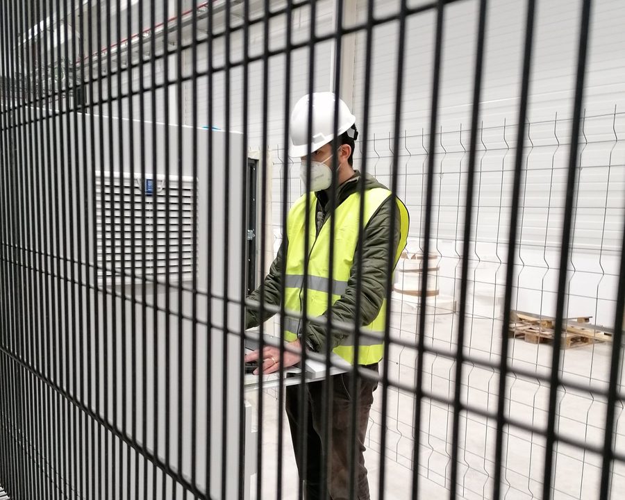 YK engineer operating a robotic production cell